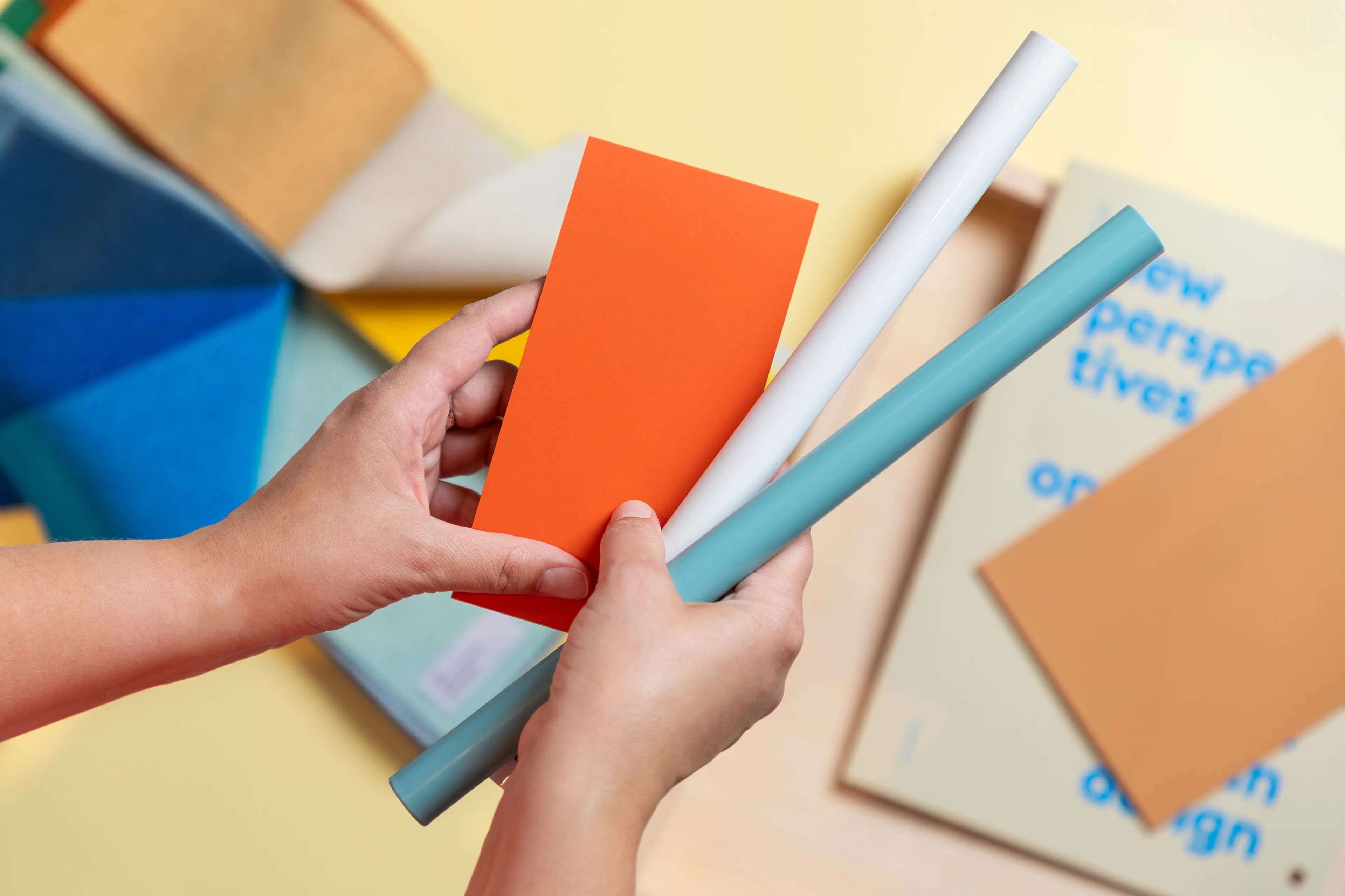 Image of hands holding material samples.