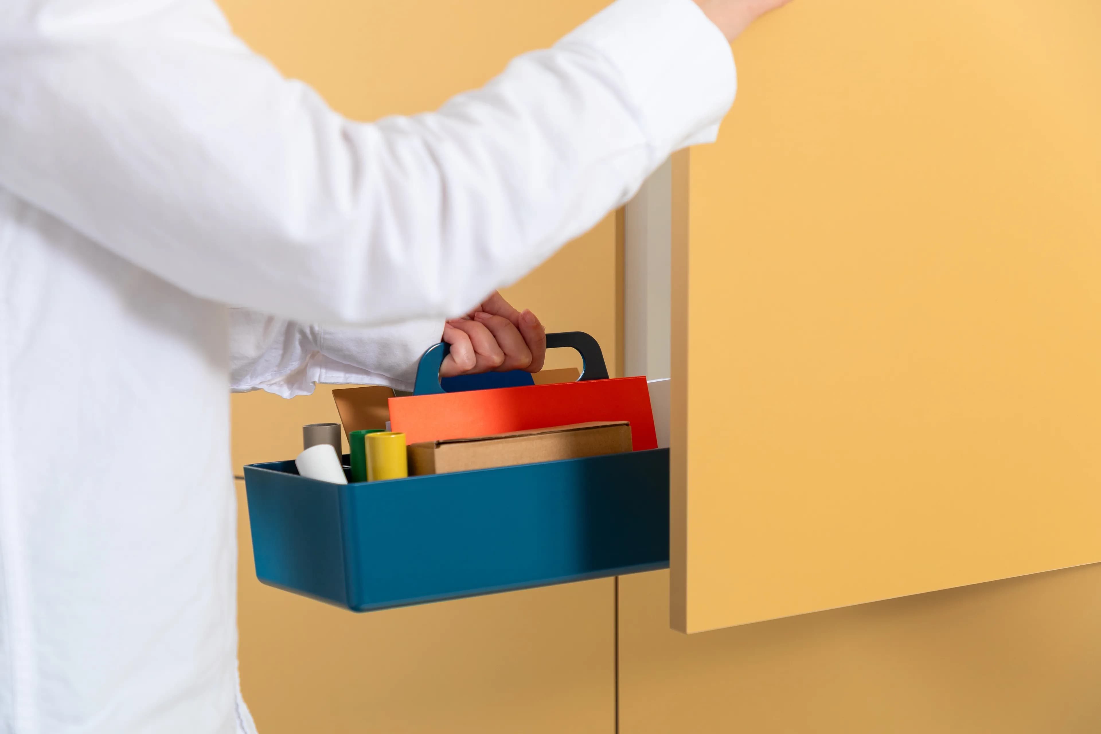 Image of a person opening a door to a storage unit.