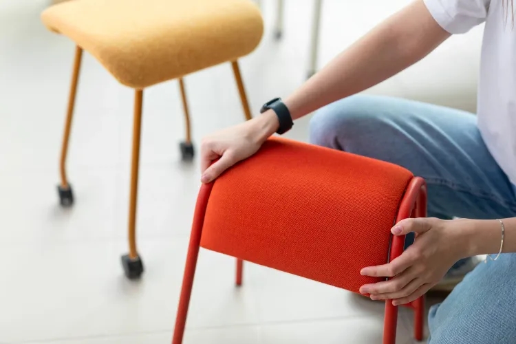 Image of a person holding a stool.